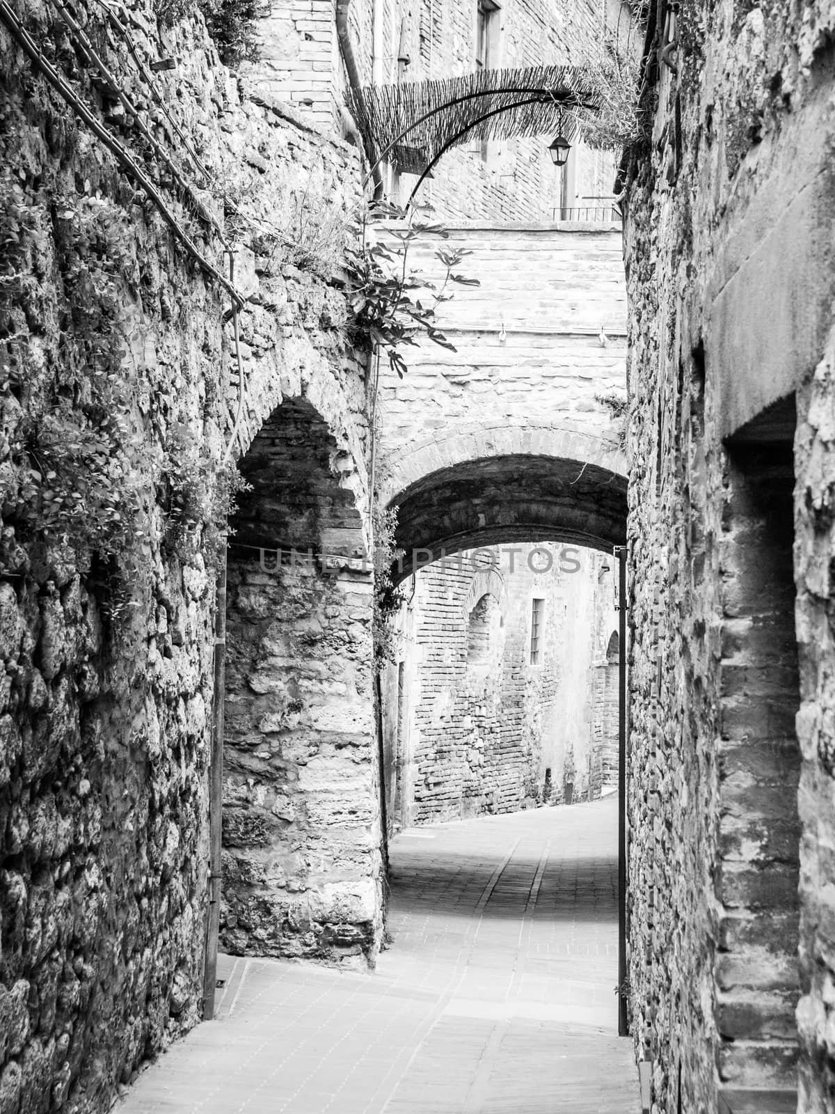 Picturesque medieval narrow street of San Gimignano old town, Tuscany, Italy by pyty