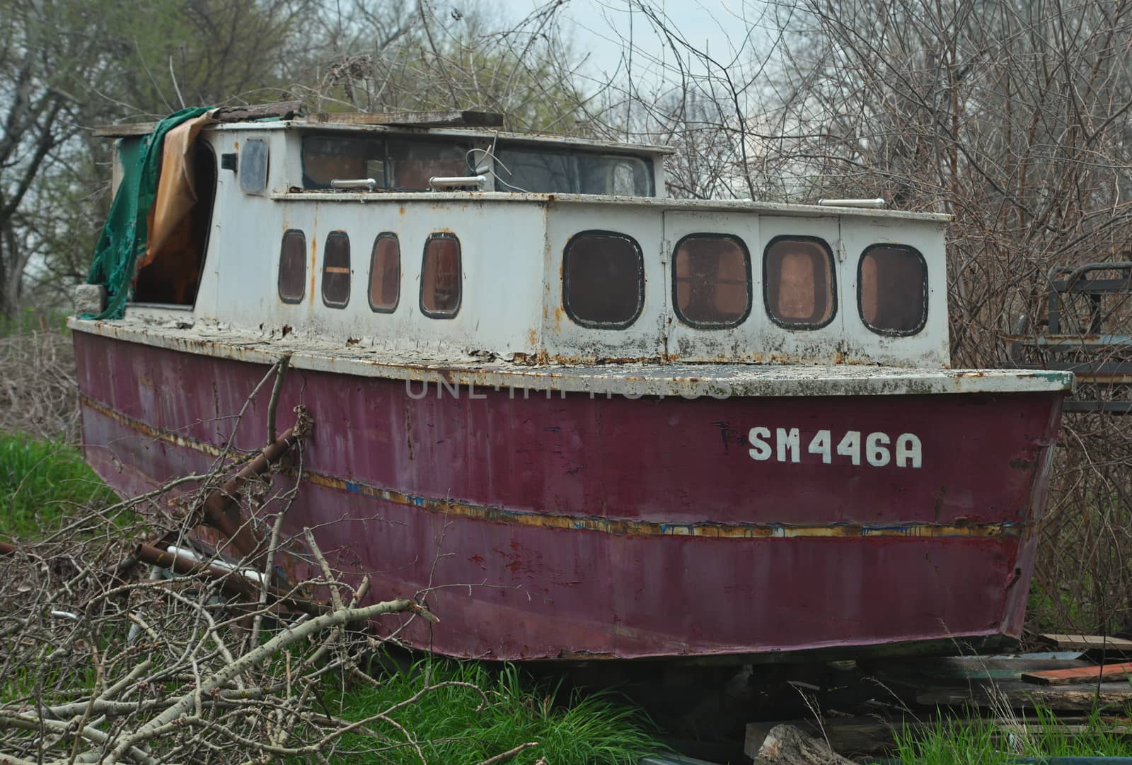 Old abandoned wrecked boat at river shore by sheriffkule