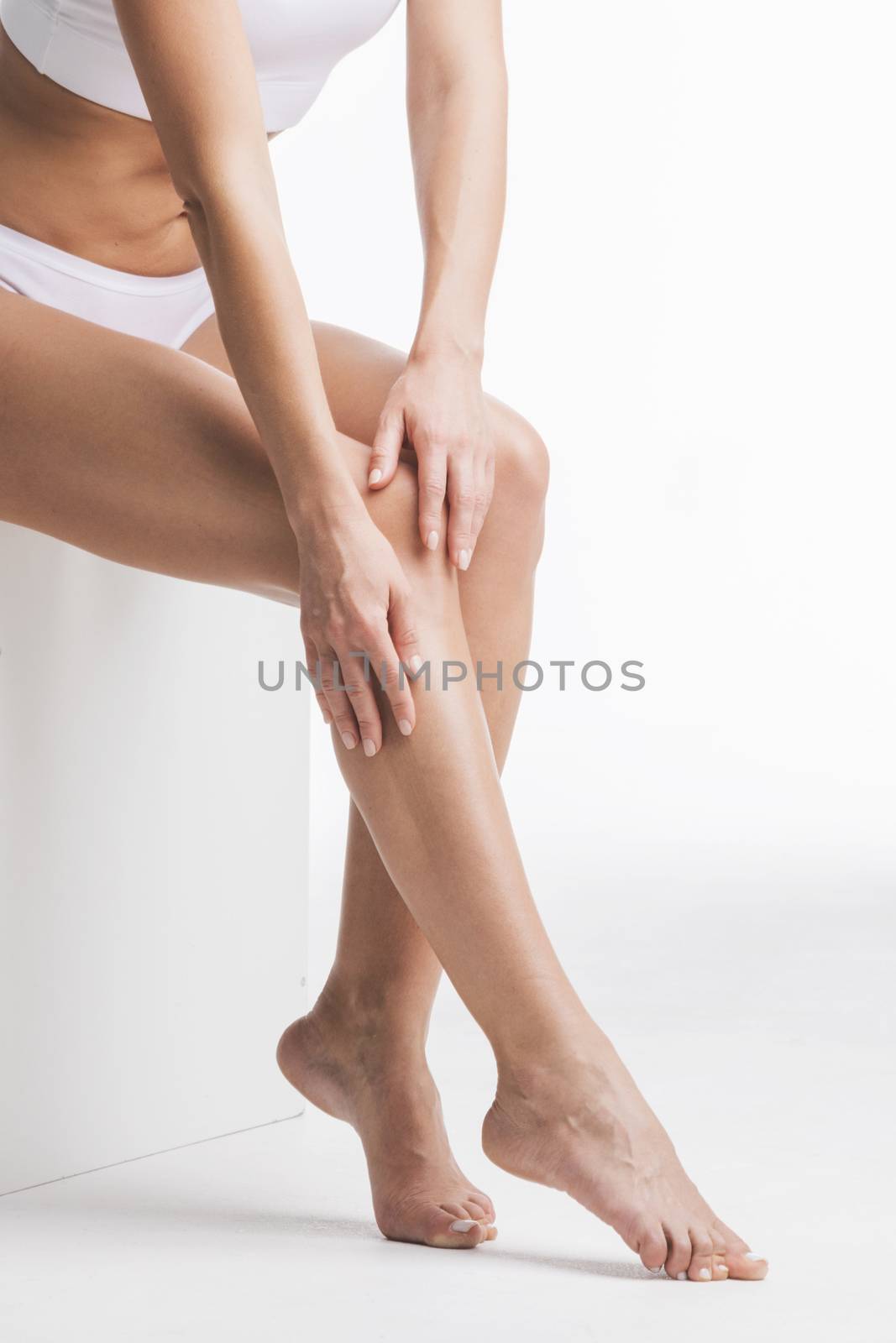 Woman touching legs by Yellowj