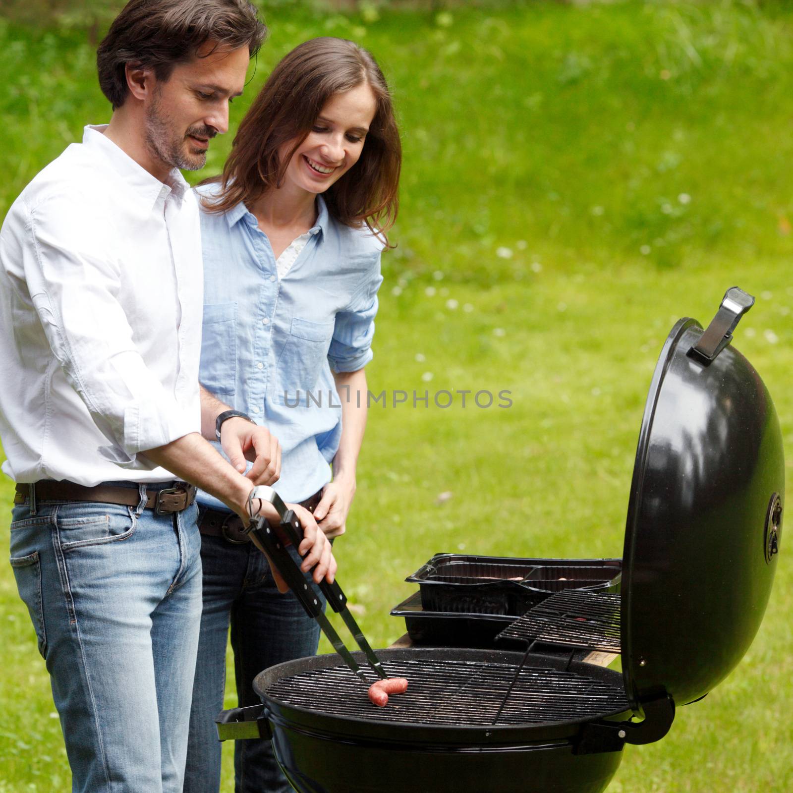 Couple cooking on barbecue  by ALotOfPeople