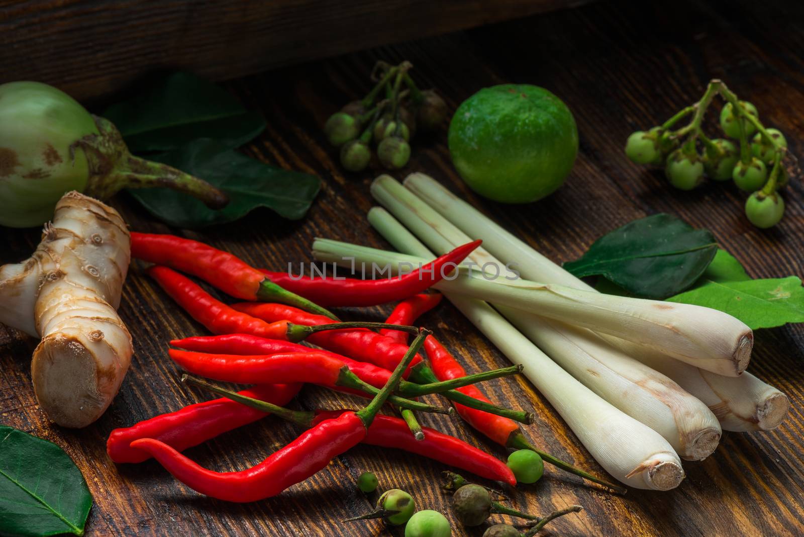 Tom yam ingredients set for Thai cuisine on dark wooden table. Vegetable background
