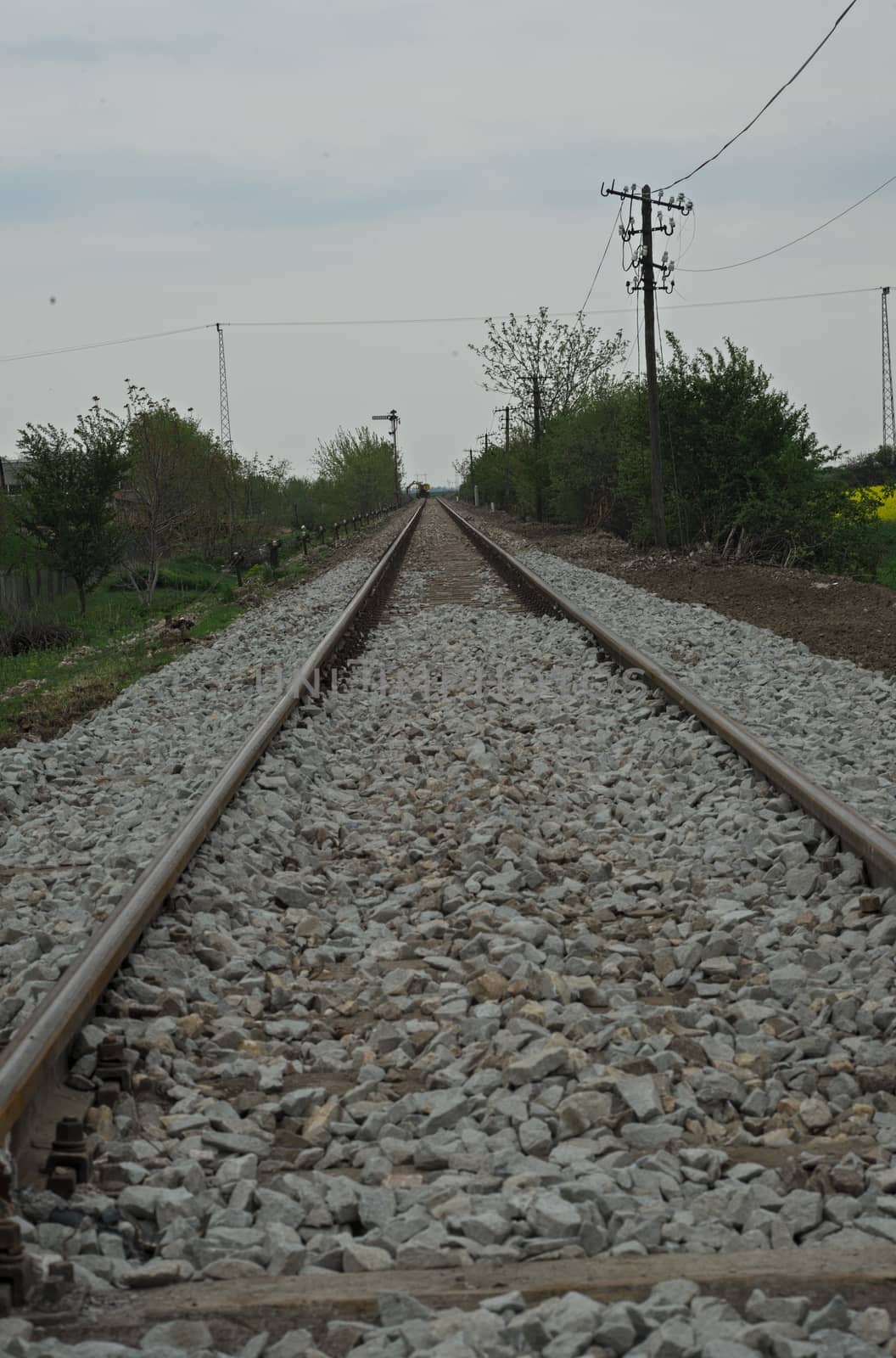 Railway tracks with white stones covering it by sheriffkule