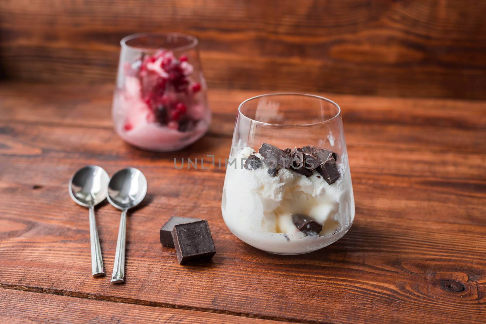 Dessert for two. Vanilla ice cream with chocolate and strawberry ice cream with red currant