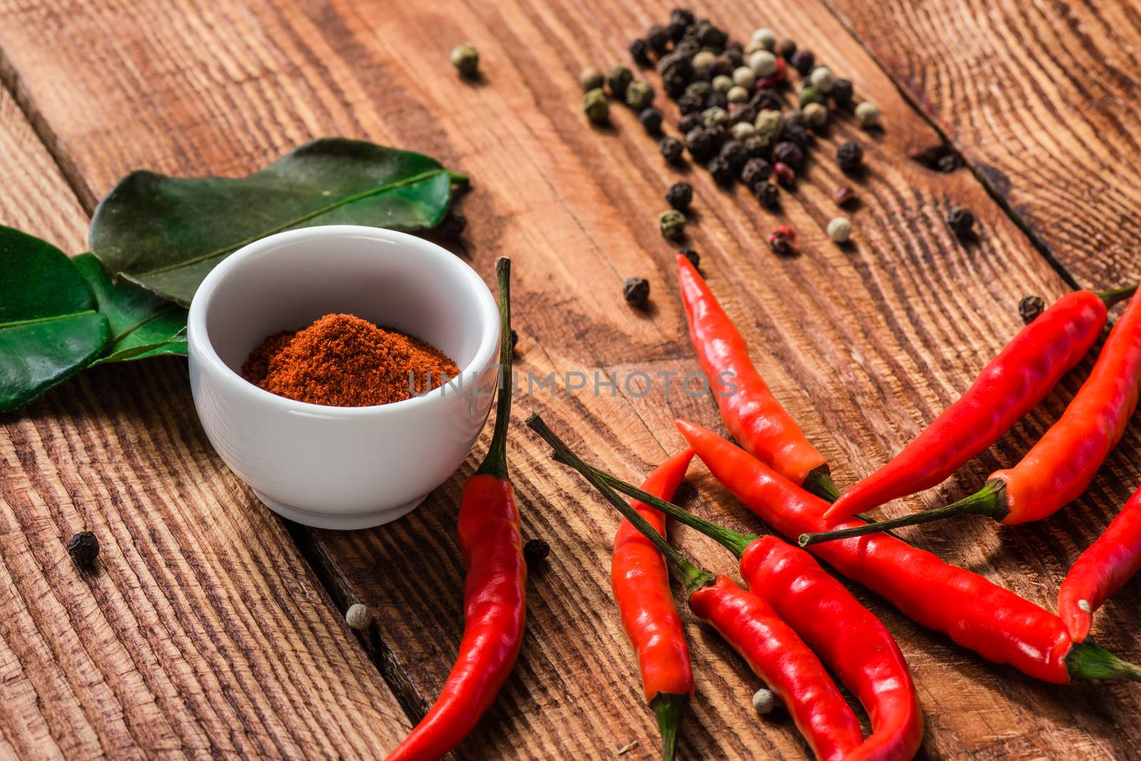 Different spices scattered on wooden table. Condiment for cooking.