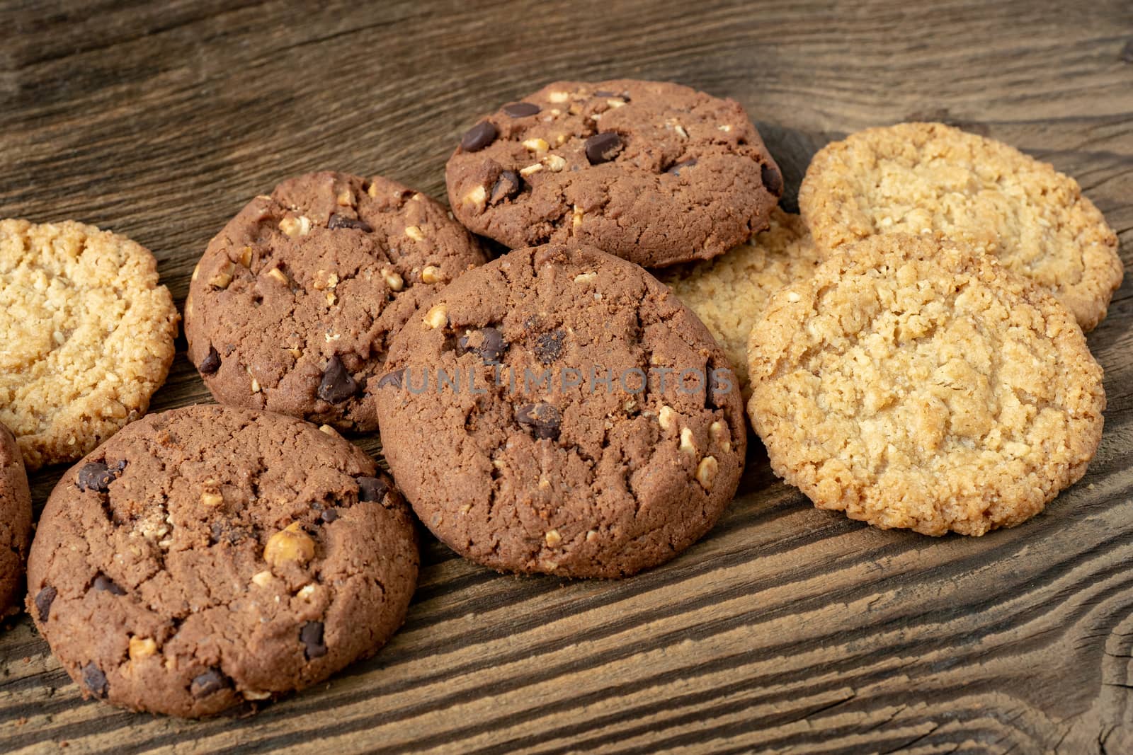 Various tasty cookies biscuits on wooden background by xtrekx