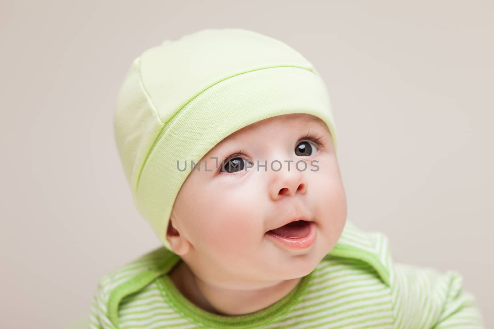 Little cute newborn baby child boy staring face