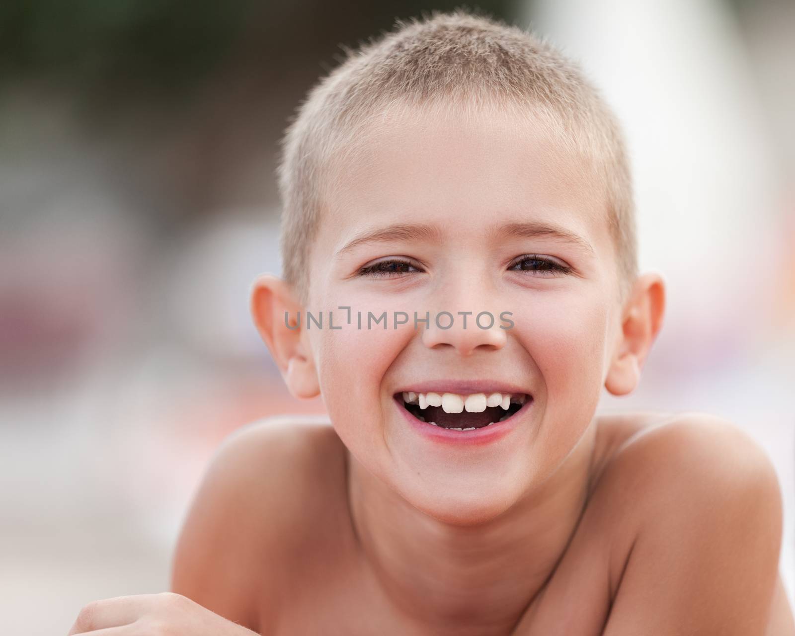 Summer vacations - handsome smiling child boy taking sunbath