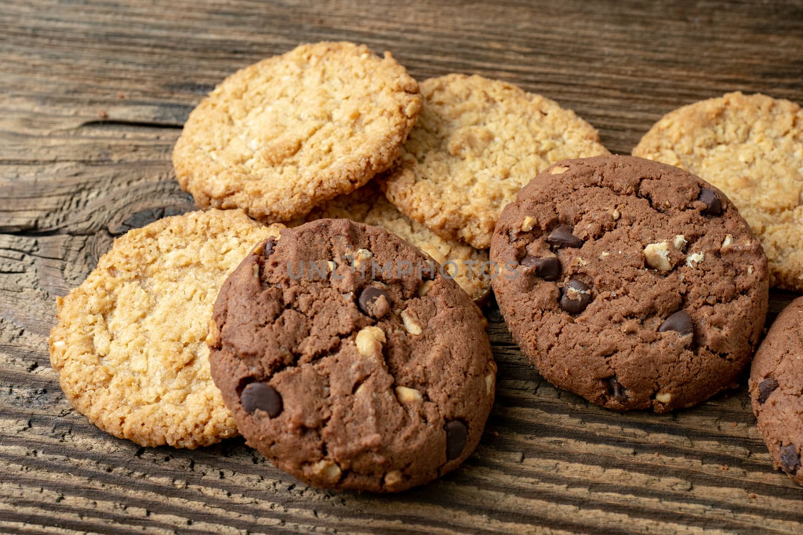 Various tasty cookies biscuits on wooden background by xtrekx