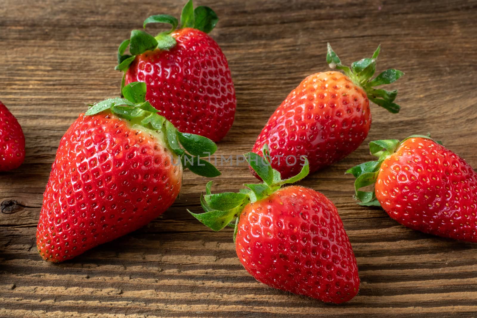 Ripe strawberries on a wooden table by xtrekx