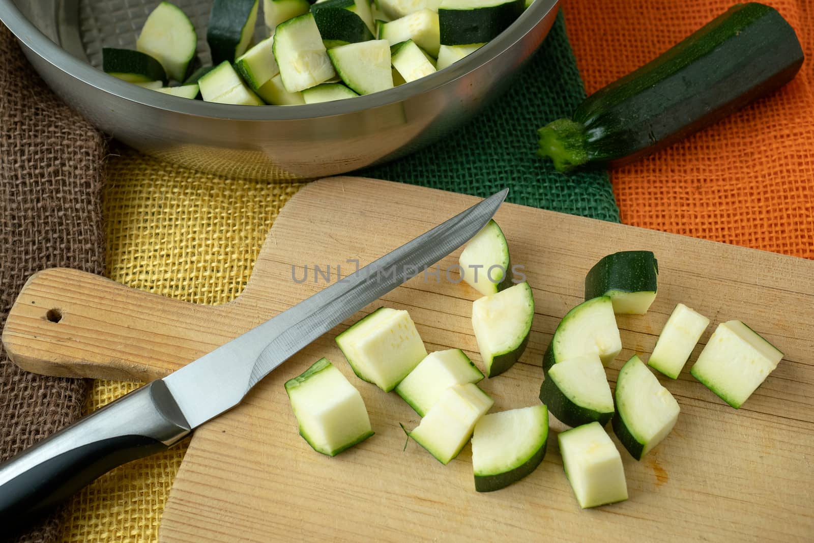 Healthy chopped zucchini on a cutting board with knife