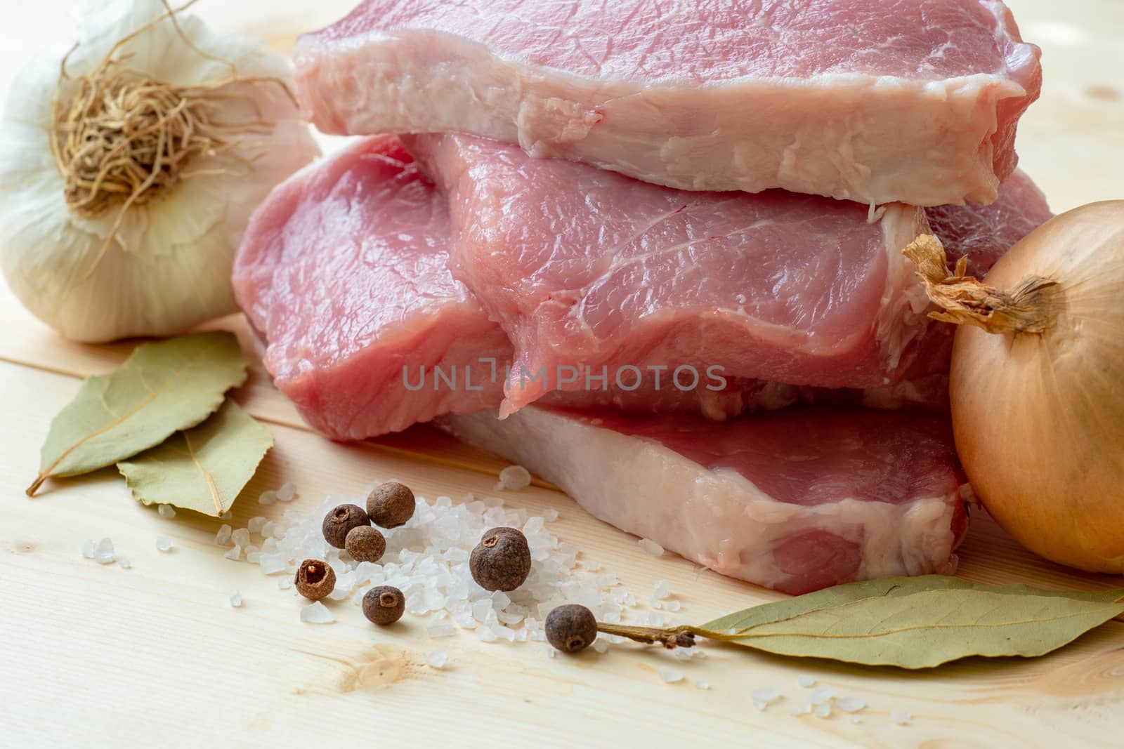 Fresh pork with ingredients for cooking on wooden board by xtrekx