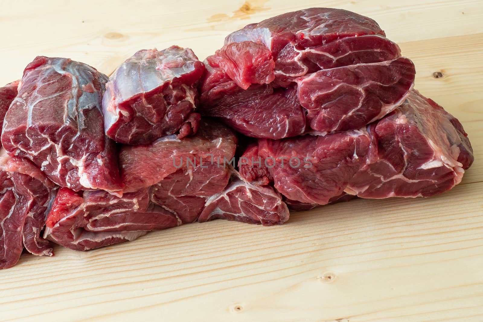 Raw breef meat on wooden table