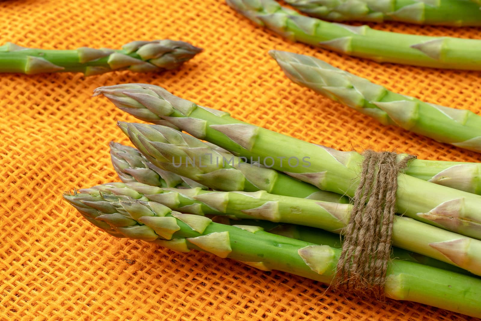 Raw garden asparagus stems. Fresh green spring vegetables on ora by xtrekx