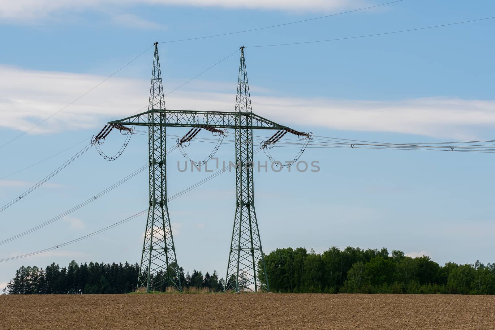 High voltage power lines with blue sky by xtrekx