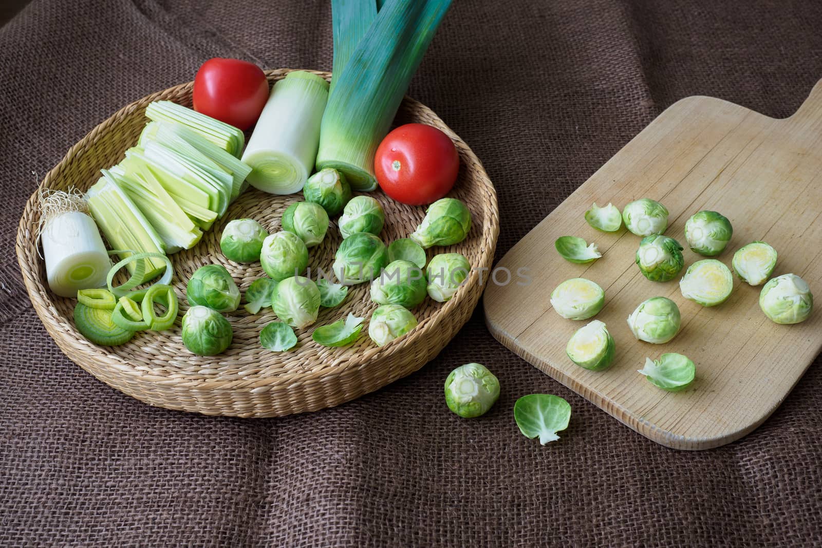 Brussels sprouts (Brassica oleracea) tomato, leek in a basket