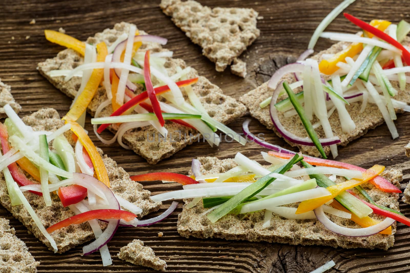 Healthy sandwiches with fresh vegetables. Breakfast toasts on wooden cutting board. Balanced breakfast.