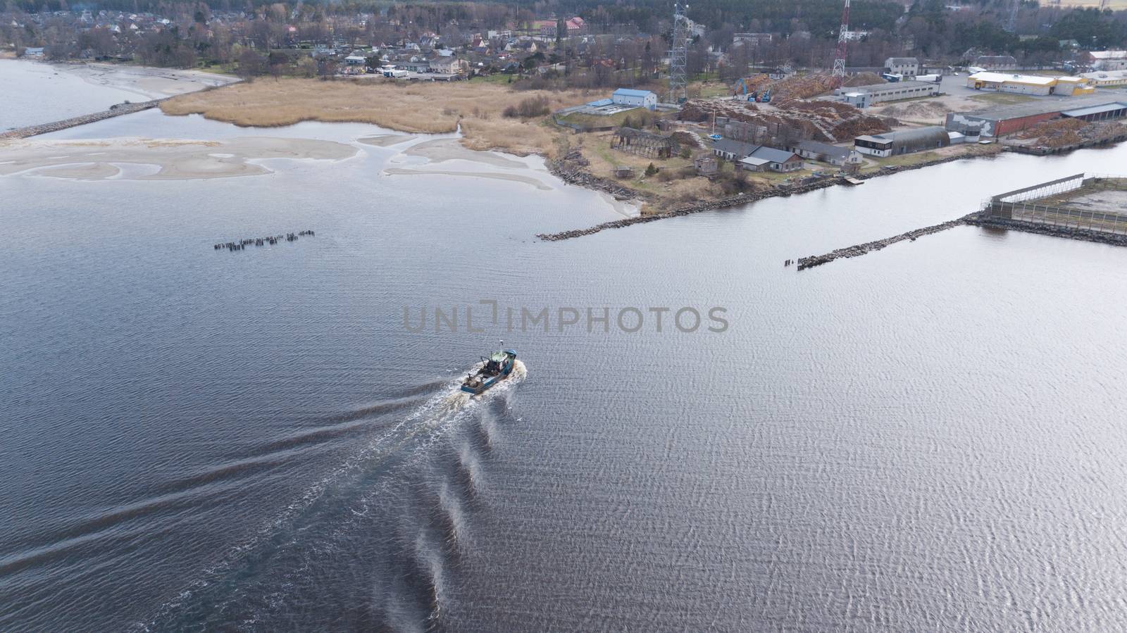 ship going in to Harbor Roja Latvia Aerial view of countryside drone top view by desant7474