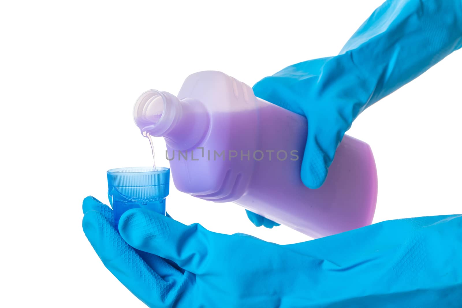 hands in gloves pour a detergent on white isolated background