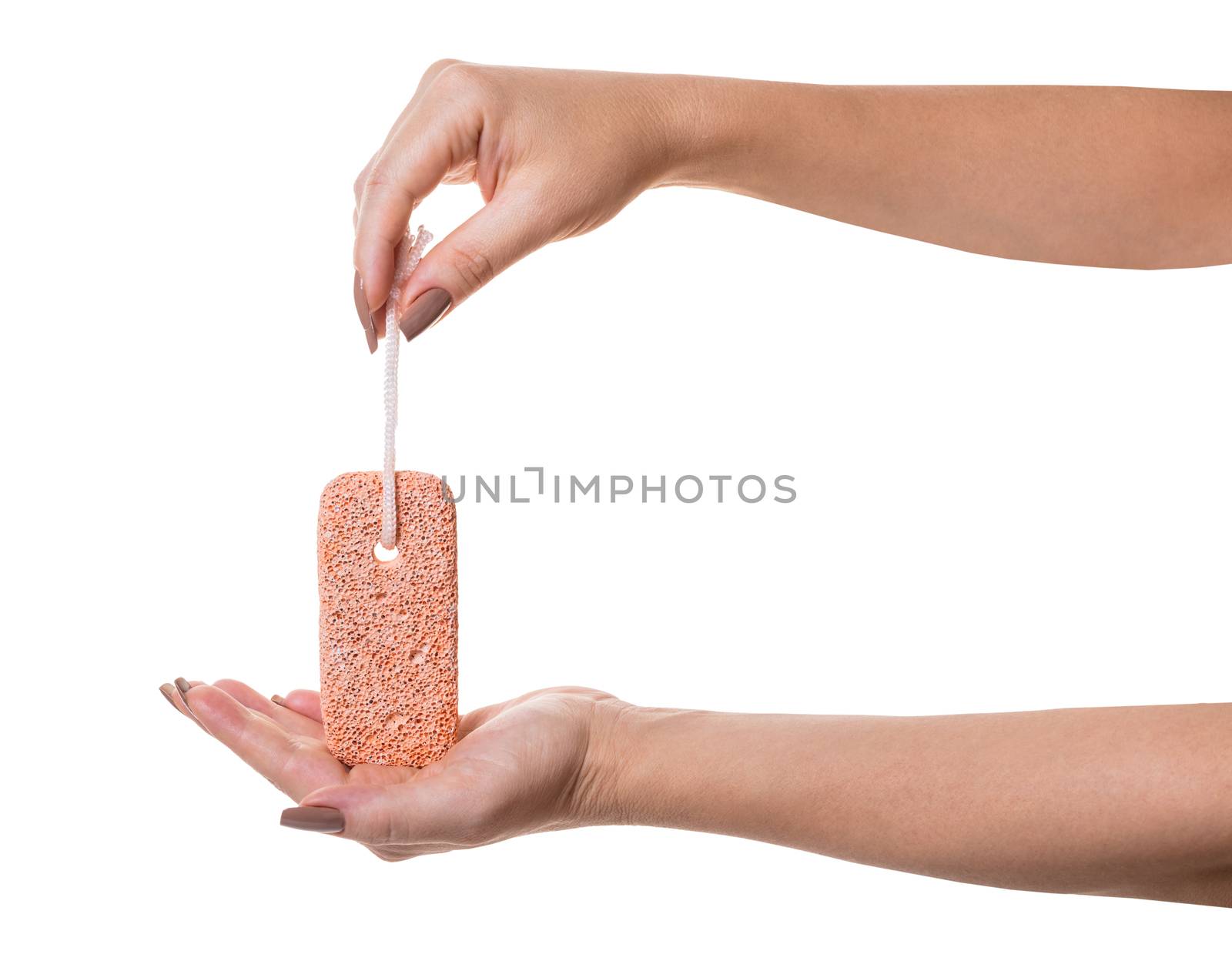 pumice stone in female hand on white isolated background