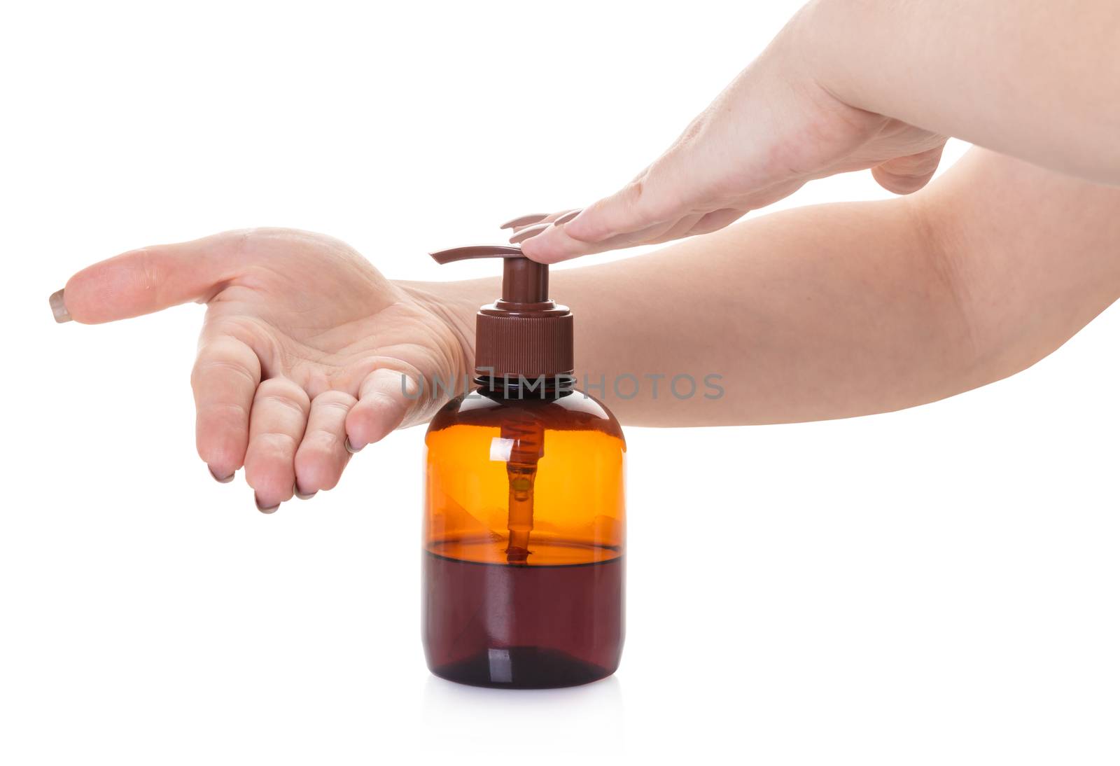 bottle with liquid soap in hand on white isolated background