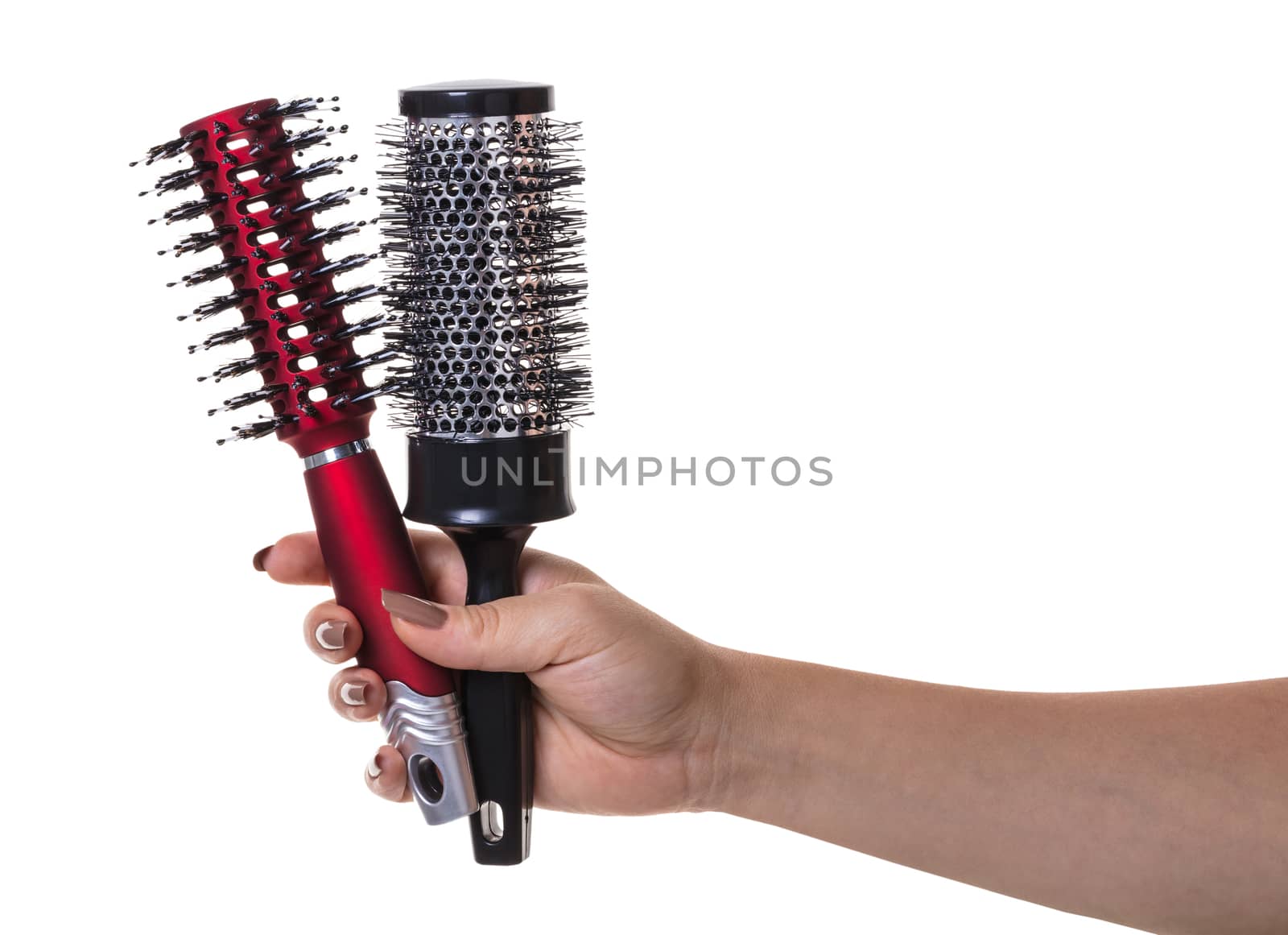 hair comb in female hand on white isolated background