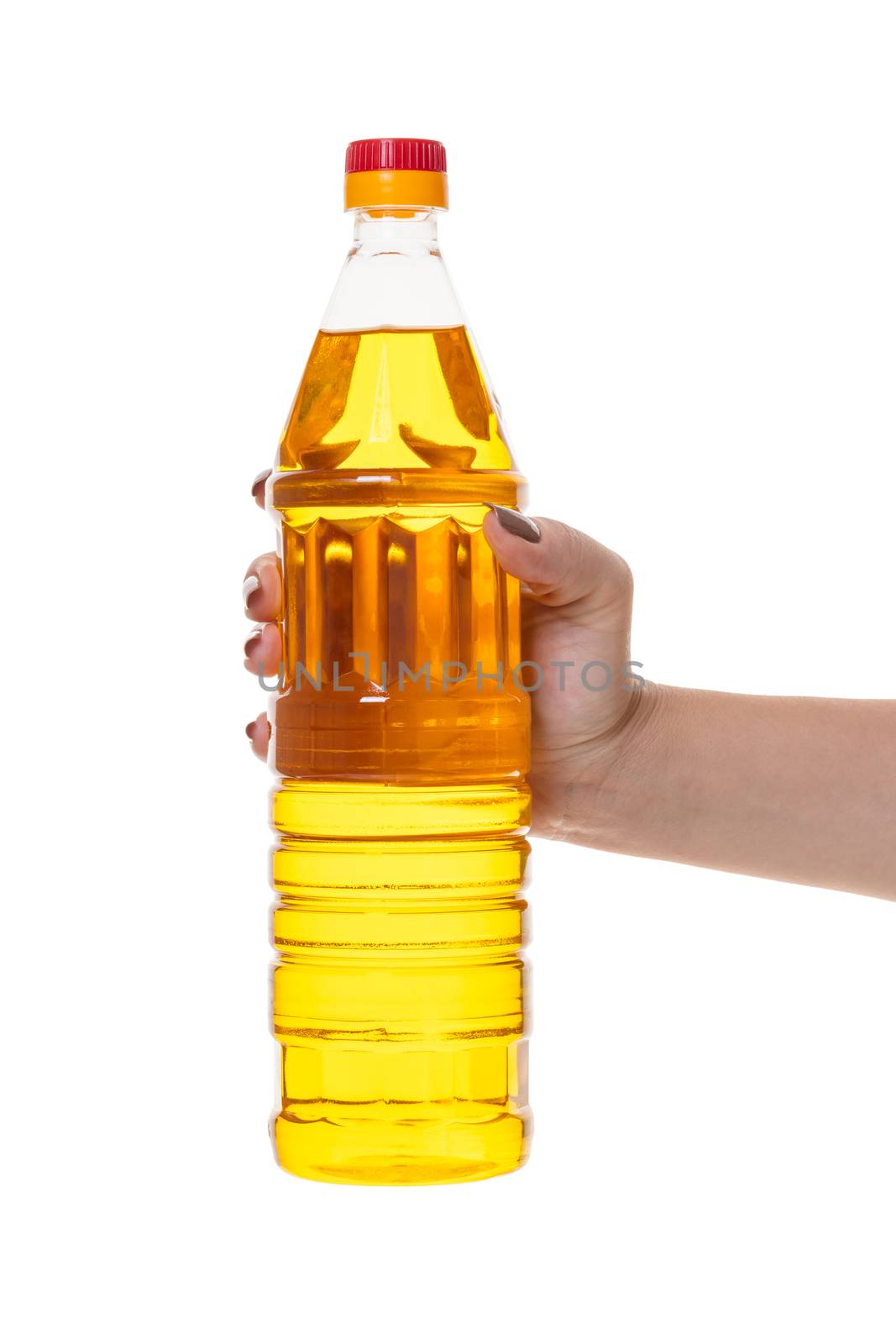 bottle with vegetable oil in hand on white isolated background