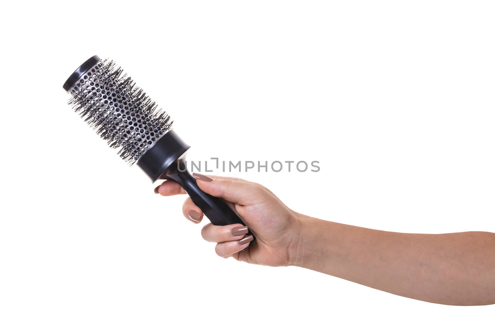 hair comb in female hand on white isolated background