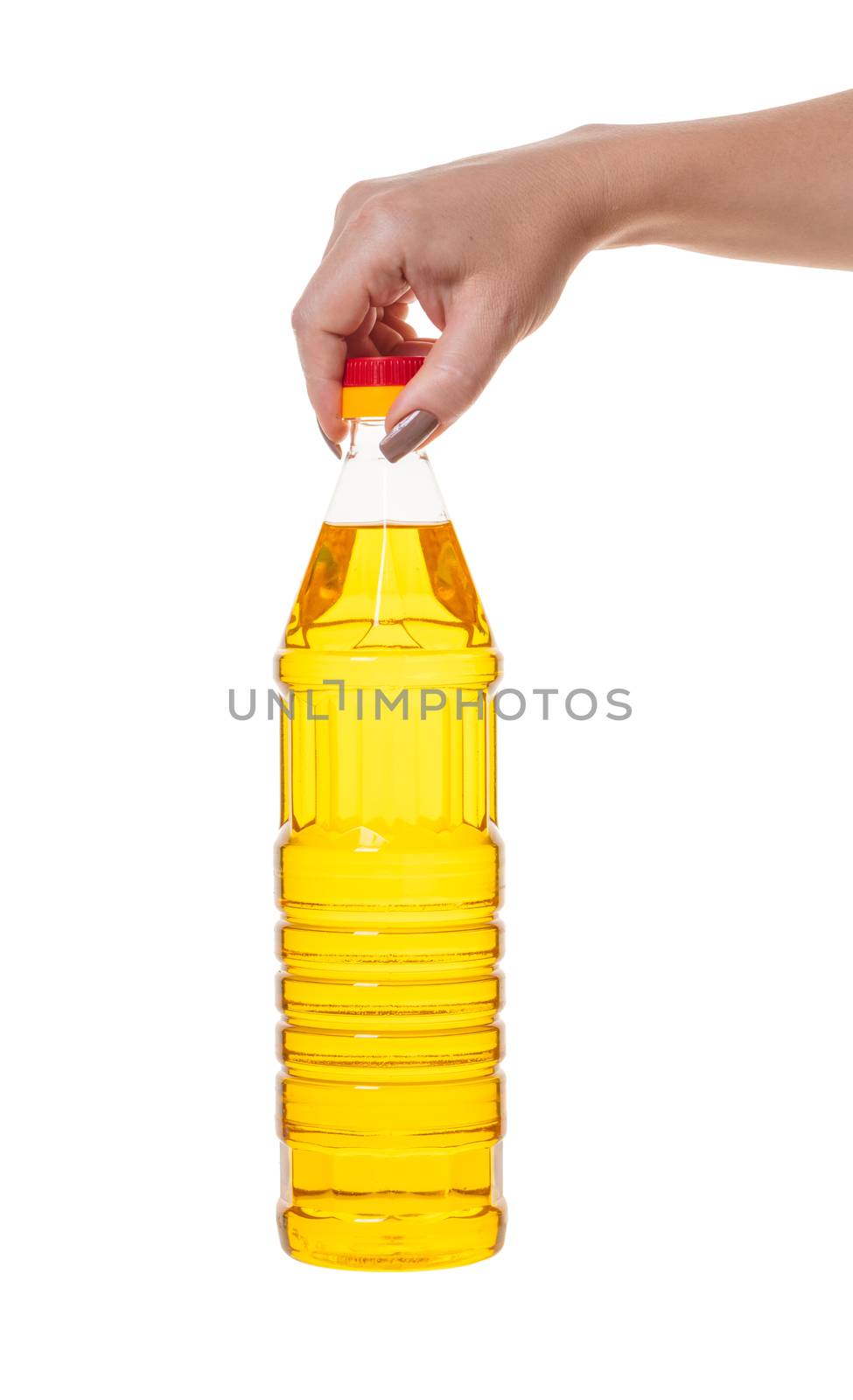 bottle with vegetable oil in hand on white isolated background