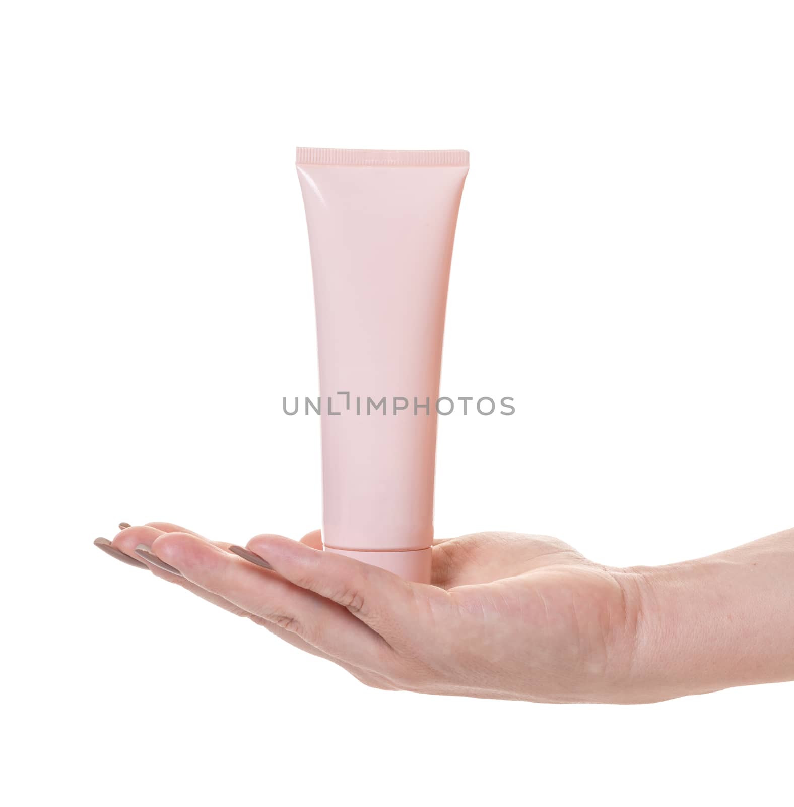 Female hand with a tube of cosmetic cream on white isolated background