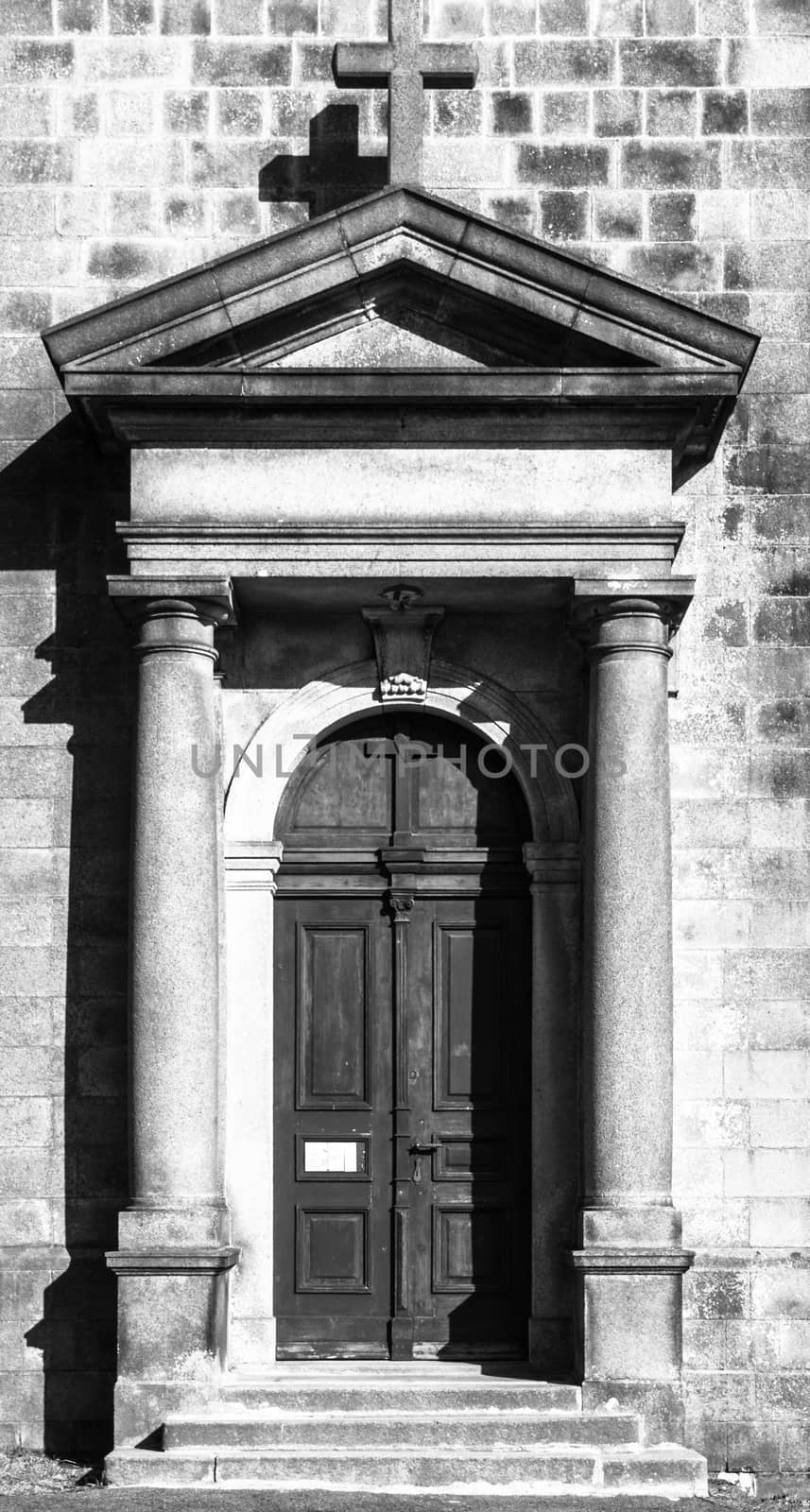 Old wooden church door. Entrance to the St Peter and Paul Church in Tanvald, Czech Republic. Black and white image.