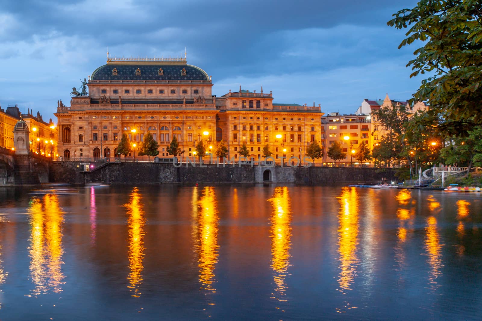 Prague National Theatre by night. Illuminated embankment and Vltava River. Prague, Czech Republic by pyty