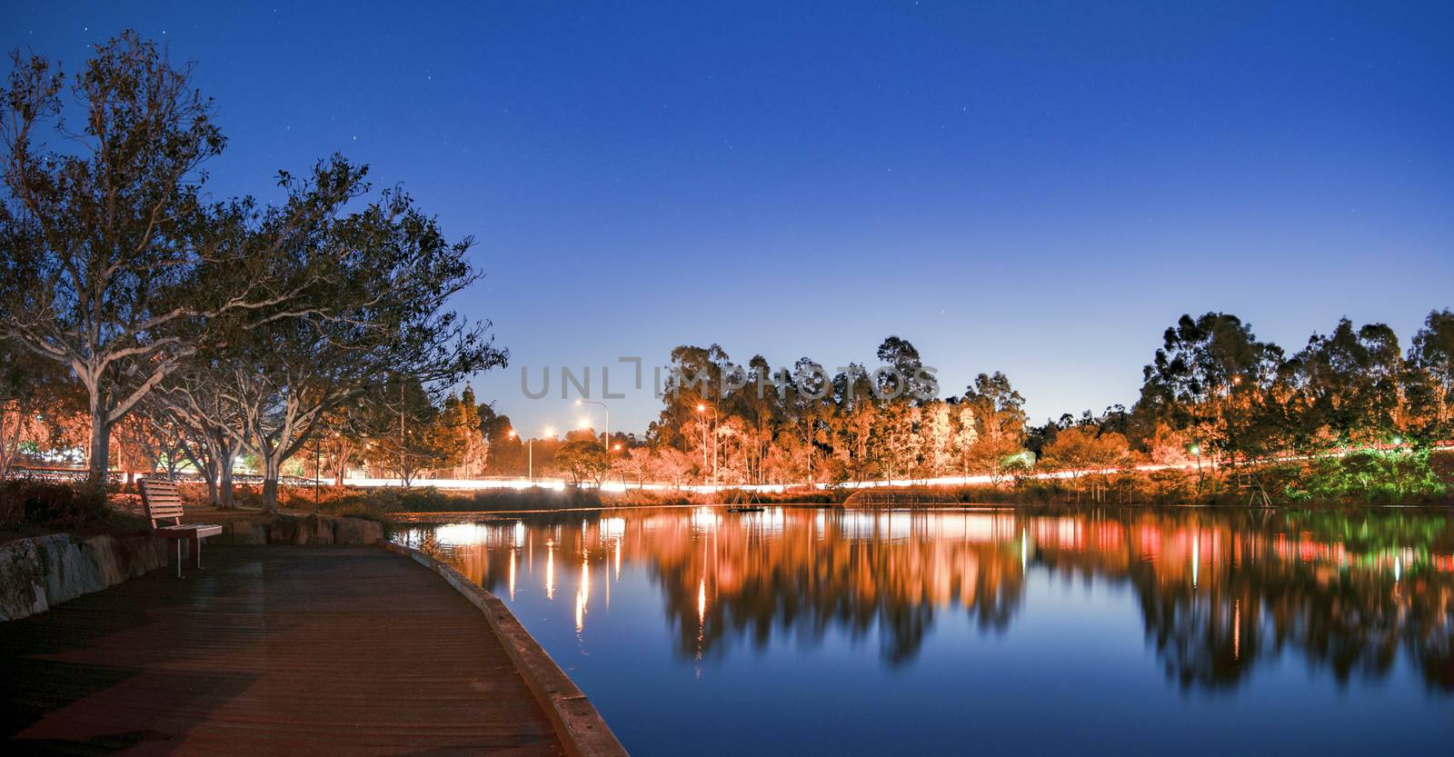 Beautiful lake in Springfield Lakes at dusk.  by artistrobd