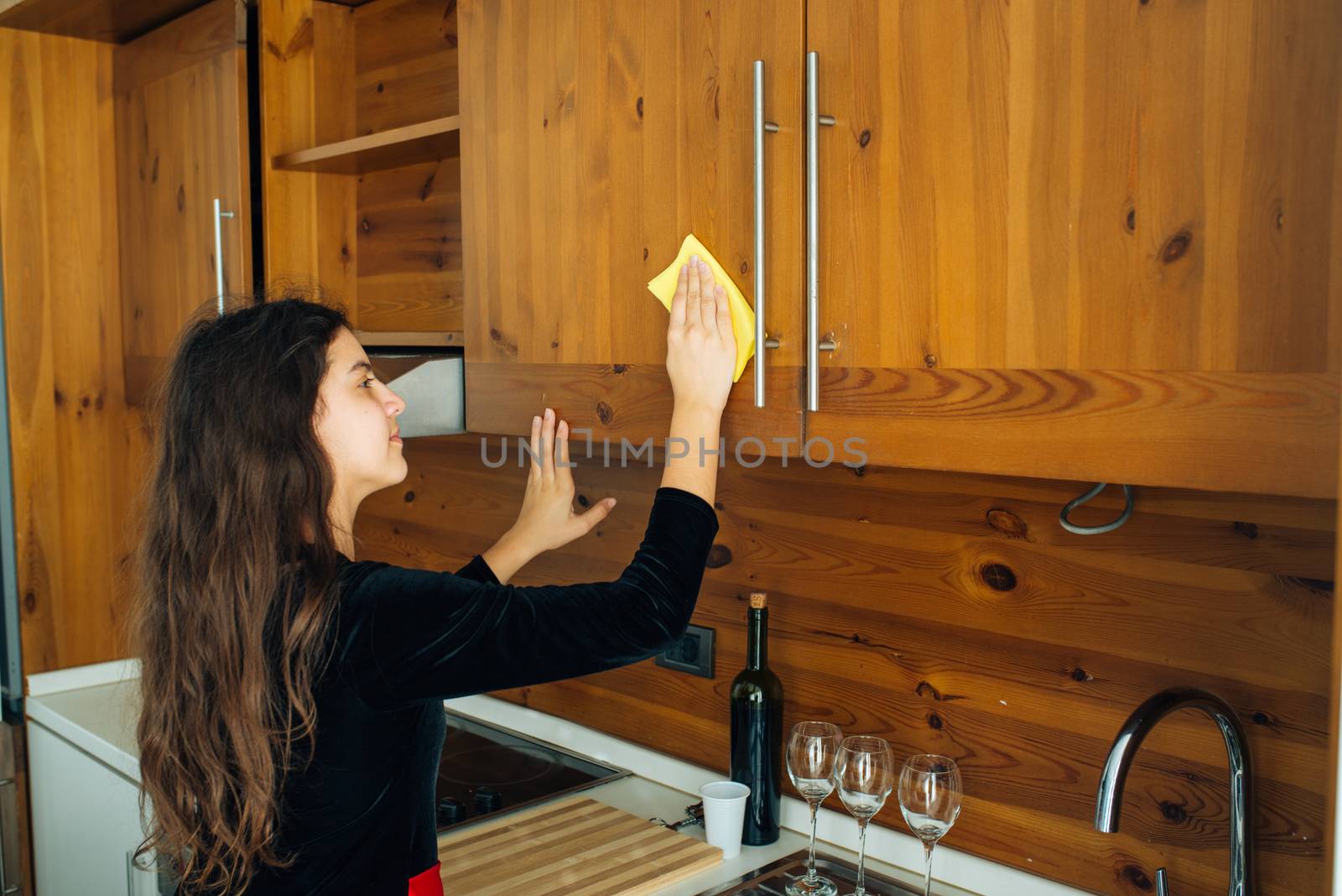 Cute Little Girl Is Cleaning The Kitchen With Yellow Rag