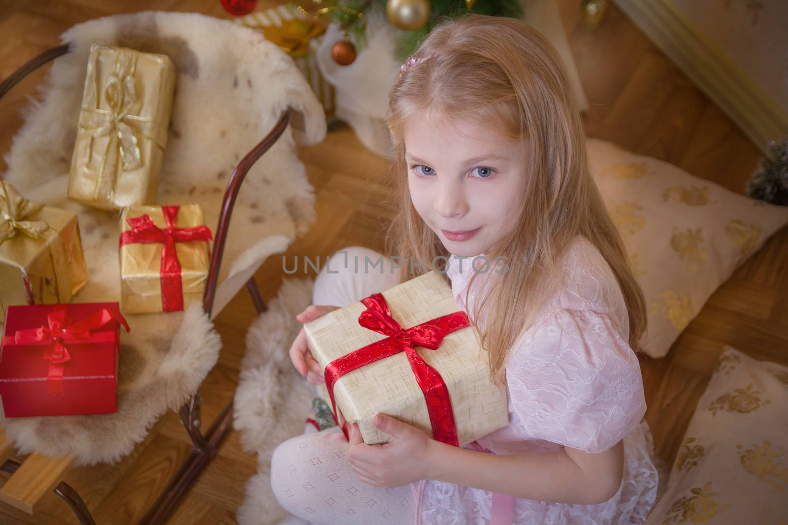 Cute girl with lot of gifts and sledge