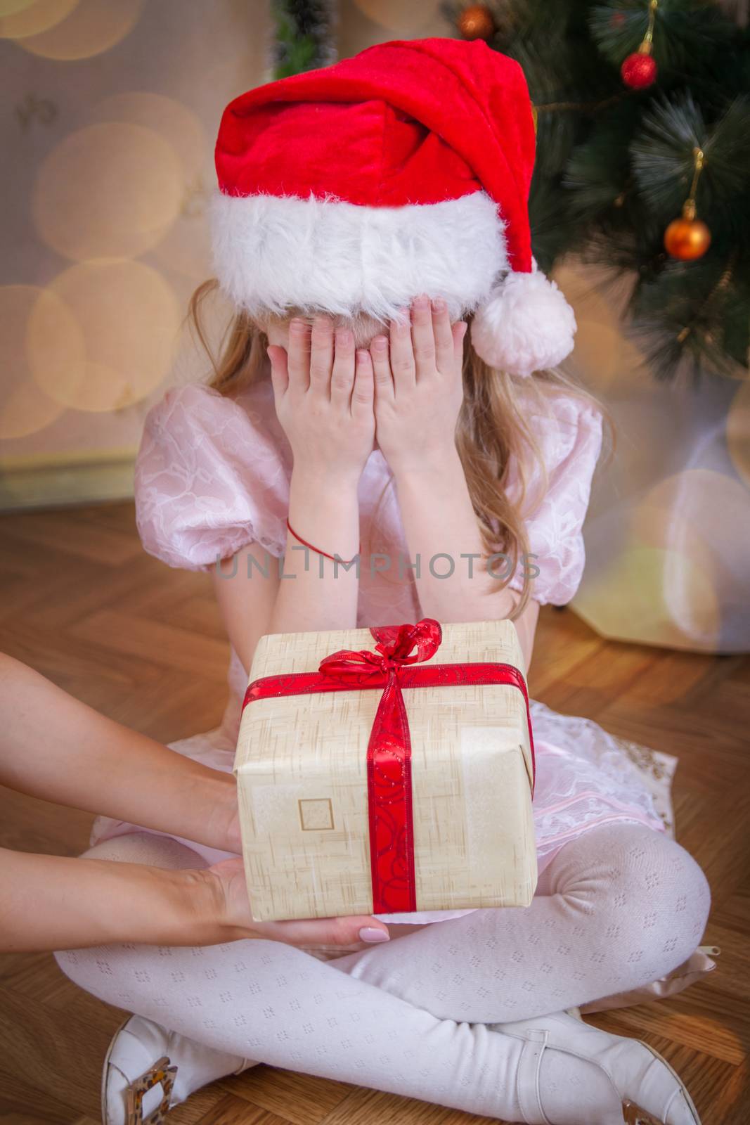 Girl eyes closed receiving Christmas gift  by Angel_a