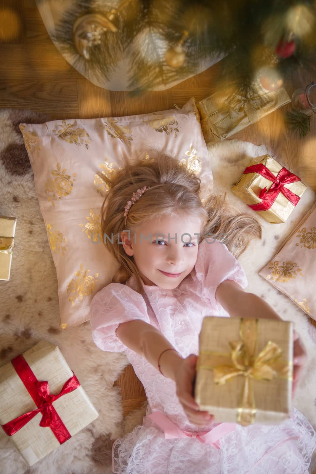 Top view of smiling female kid with lots of presents