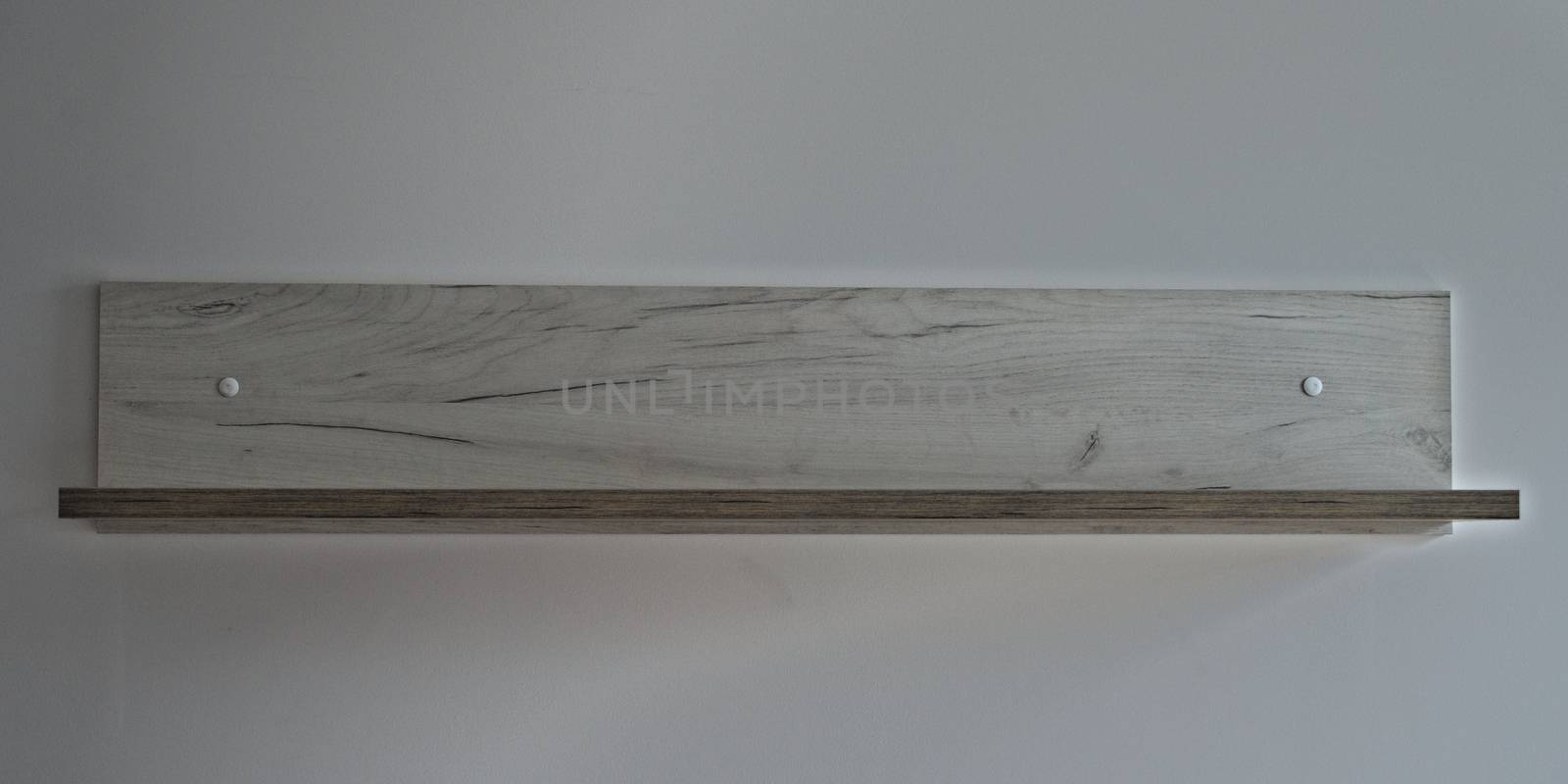 Gray wooden shelf on white wall, front view by sheriffkule