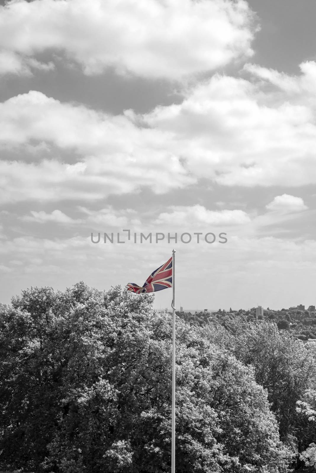 union jack flag flying from a pole in london in black and white