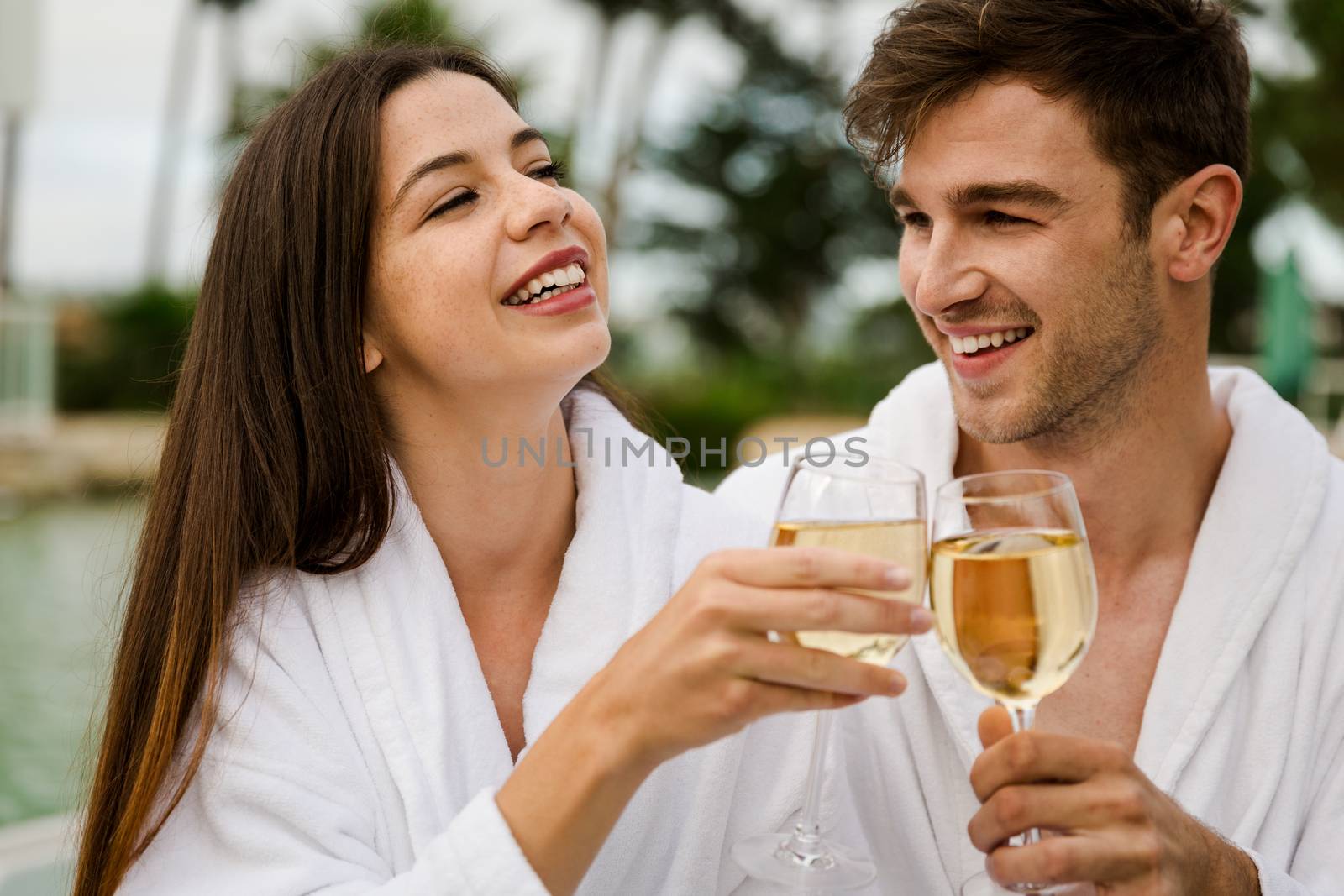 Young couple tasting wine by Iko