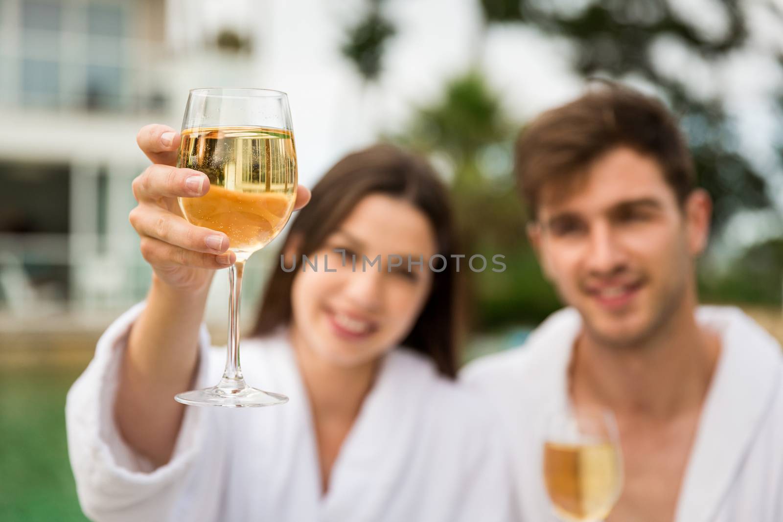 Young couple tasting wine by Iko