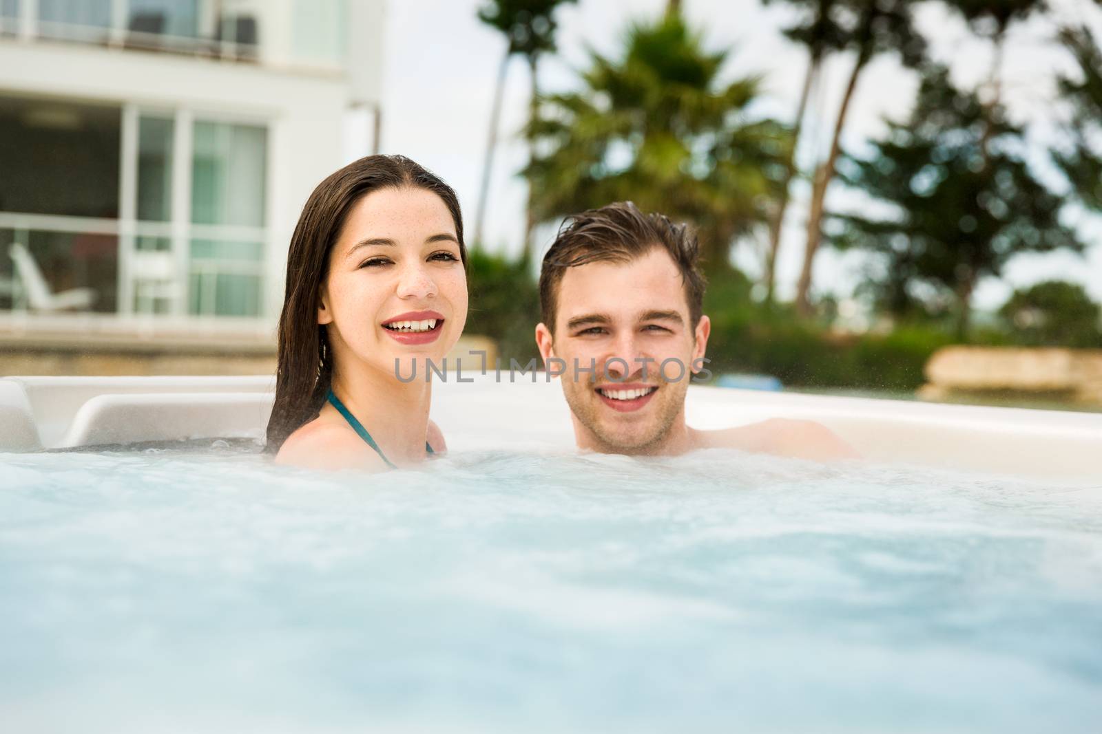 Young couple in a jacuzzi by Iko