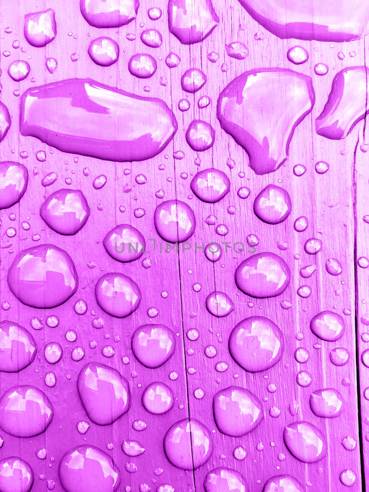 rain drops on on purple wooden bench