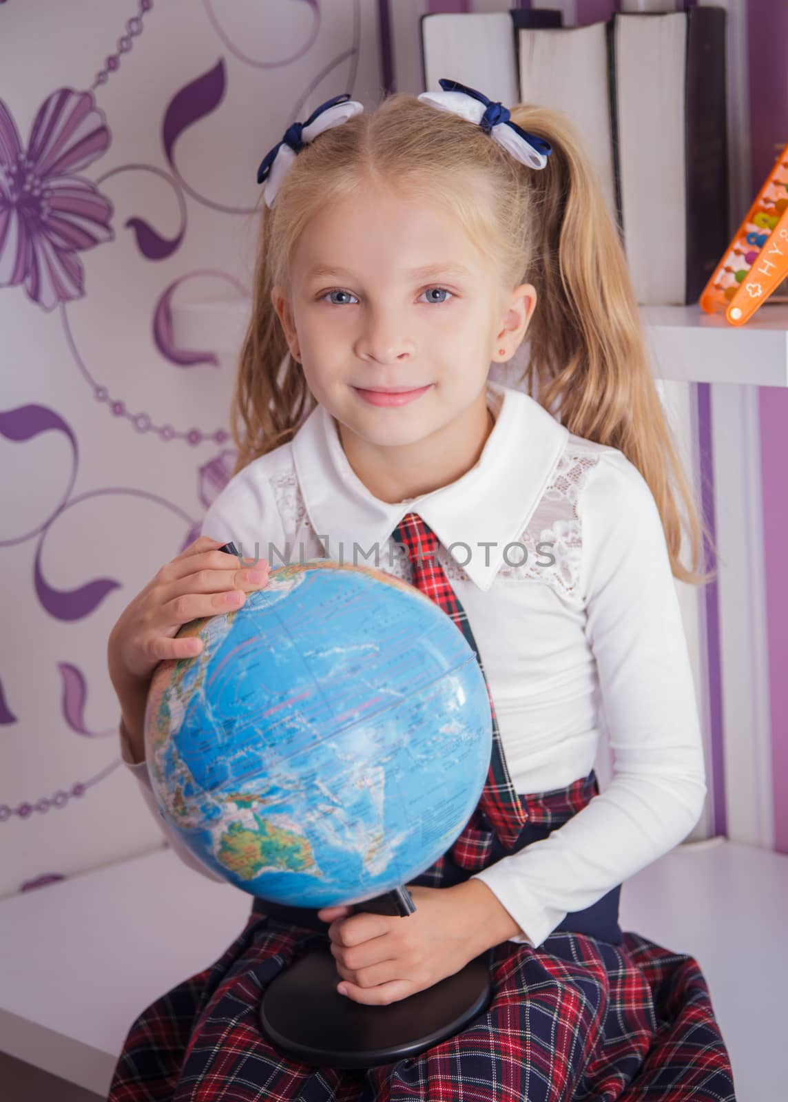 Schoolgirl with globe sitting on table, school and education con by Angel_a