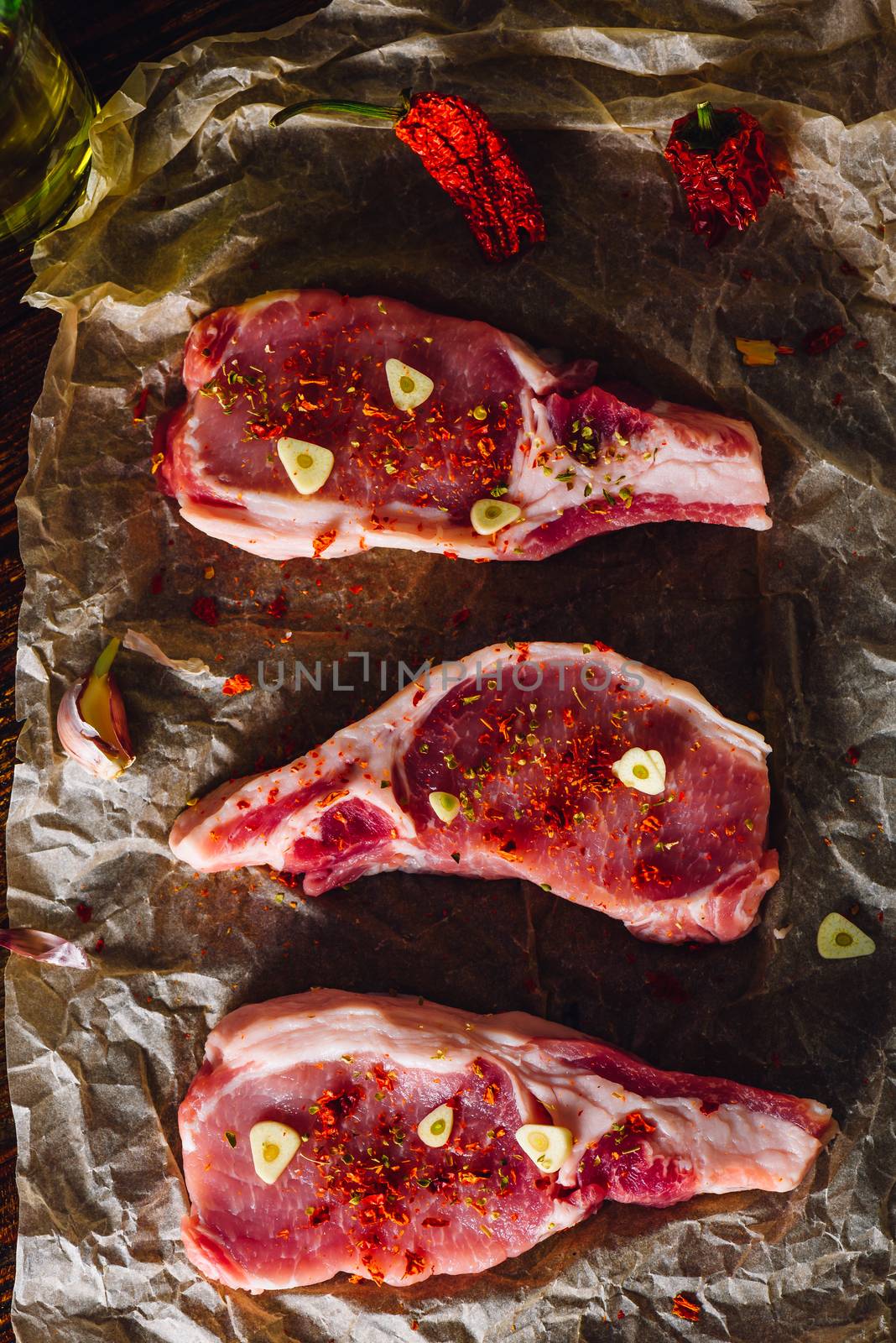 Three Pork Loin Steaks Prepared for Roasting. View from Above