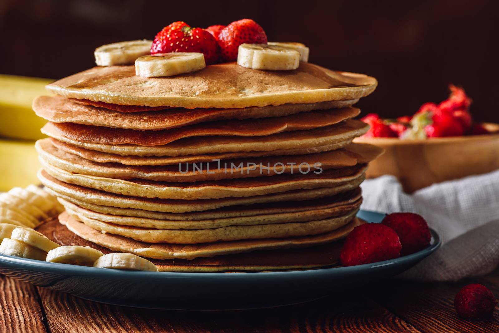 Pancake Stack with Strawberry and Banana Slices.