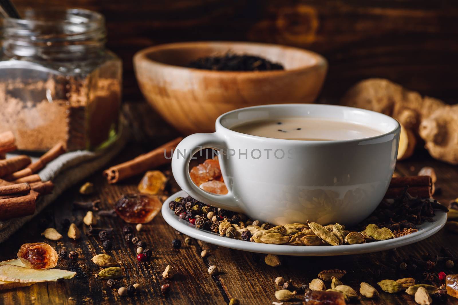 Masala Chai in White Cup with Different Spices on Wooden Table