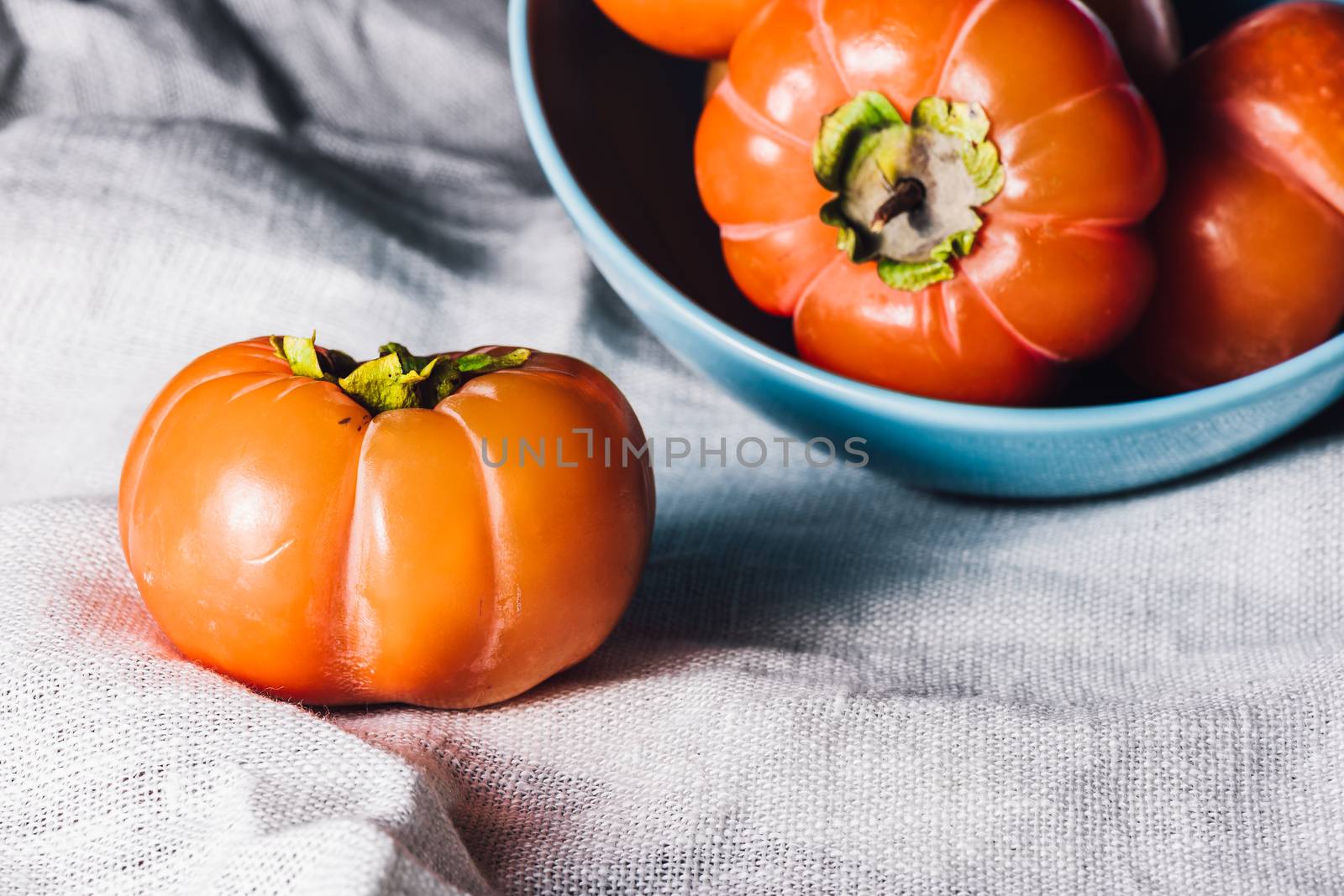 One Persimmon Near the Bowl of Persimmons by Seva_blsv