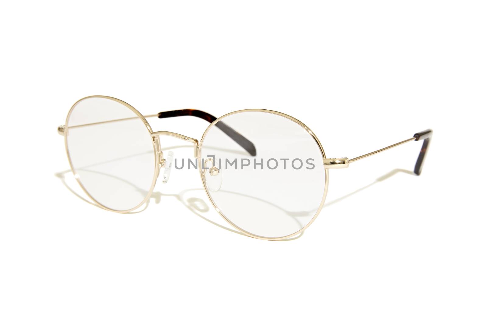 Photo of gold glasses with shadow isolated on white background.