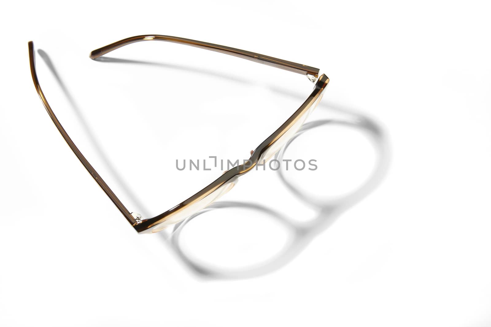Studio shot of pair of eyeglasses on white background with shadow.
