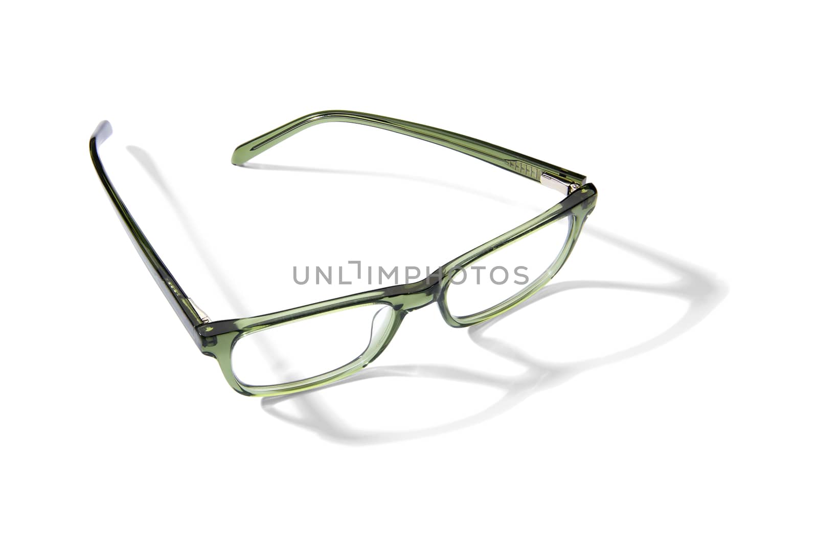 Studio shot of pair of green eyeglasses on white background with shadow.